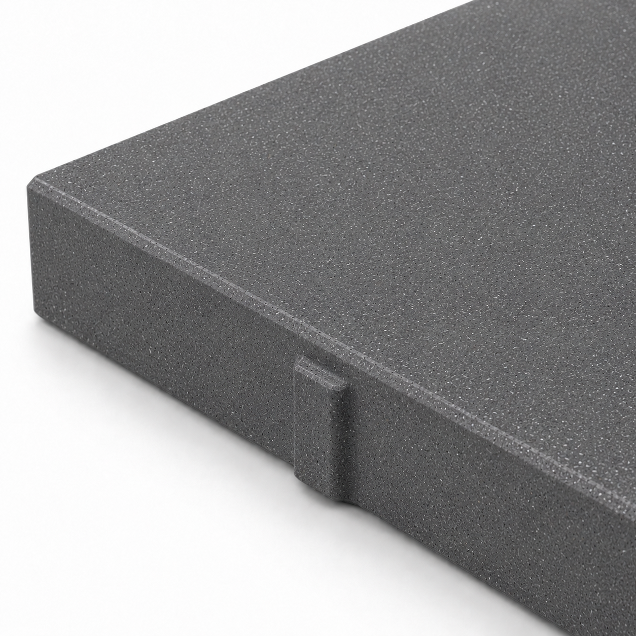 Close-up of a ModaPAVE 32x16 grade-set wet-cast concrete paver in Graphite showing the micro-terrazzo surface and eased edge — ModaConcrete