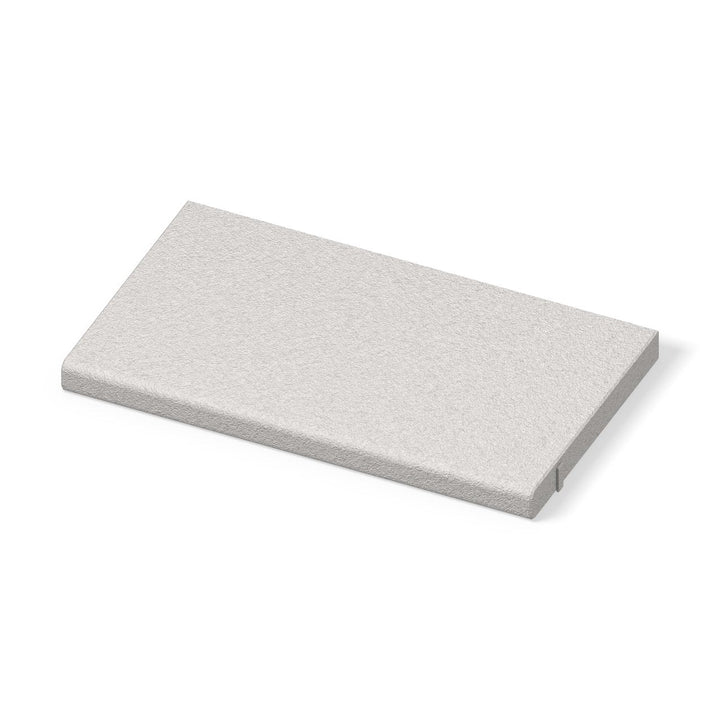 ModaPAVE straight concrete pool coping in White, bullnose water edge and bush-hammered top, three-quarter view