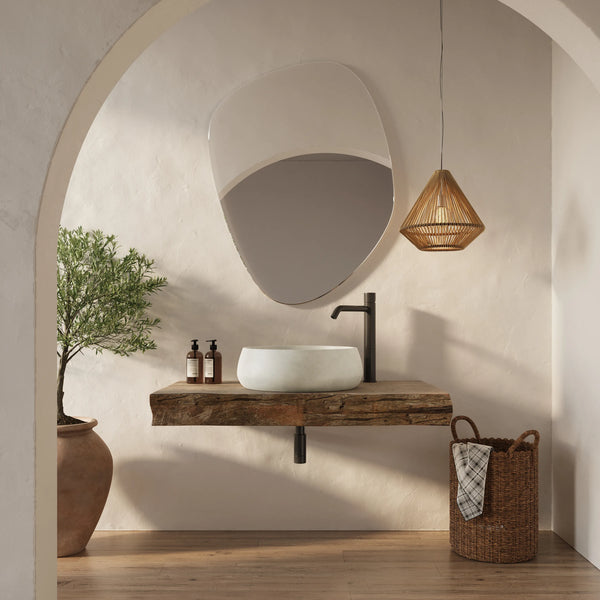 Pebble ModaCAST GFRC concrete vessel sink on a reclaimed wood shelf in an arched plaster bathroom