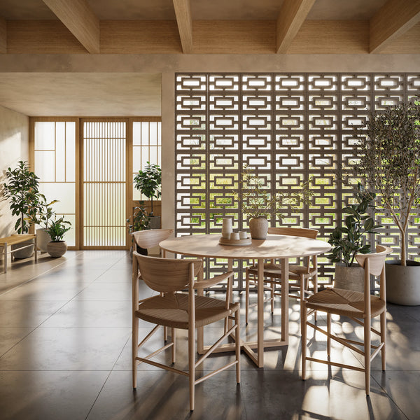 ModaBLOK TERRA breeze block screen wall dividing a sunlit dining room with wood chairs